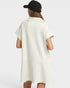 Person wearing a white dress with short sleeves on a plain background