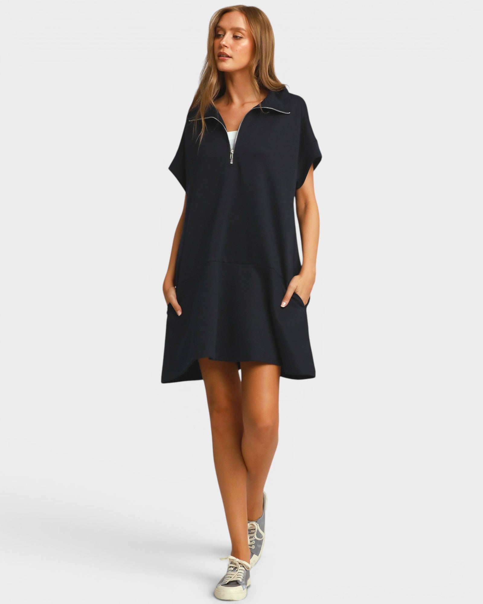Woman wearing a black dress with a zipper on a white background