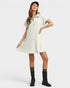 Woman wearing a white dress with black boots on a white background