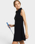 Woman wearing a navy sleeveless dress holding a blue object against a white background