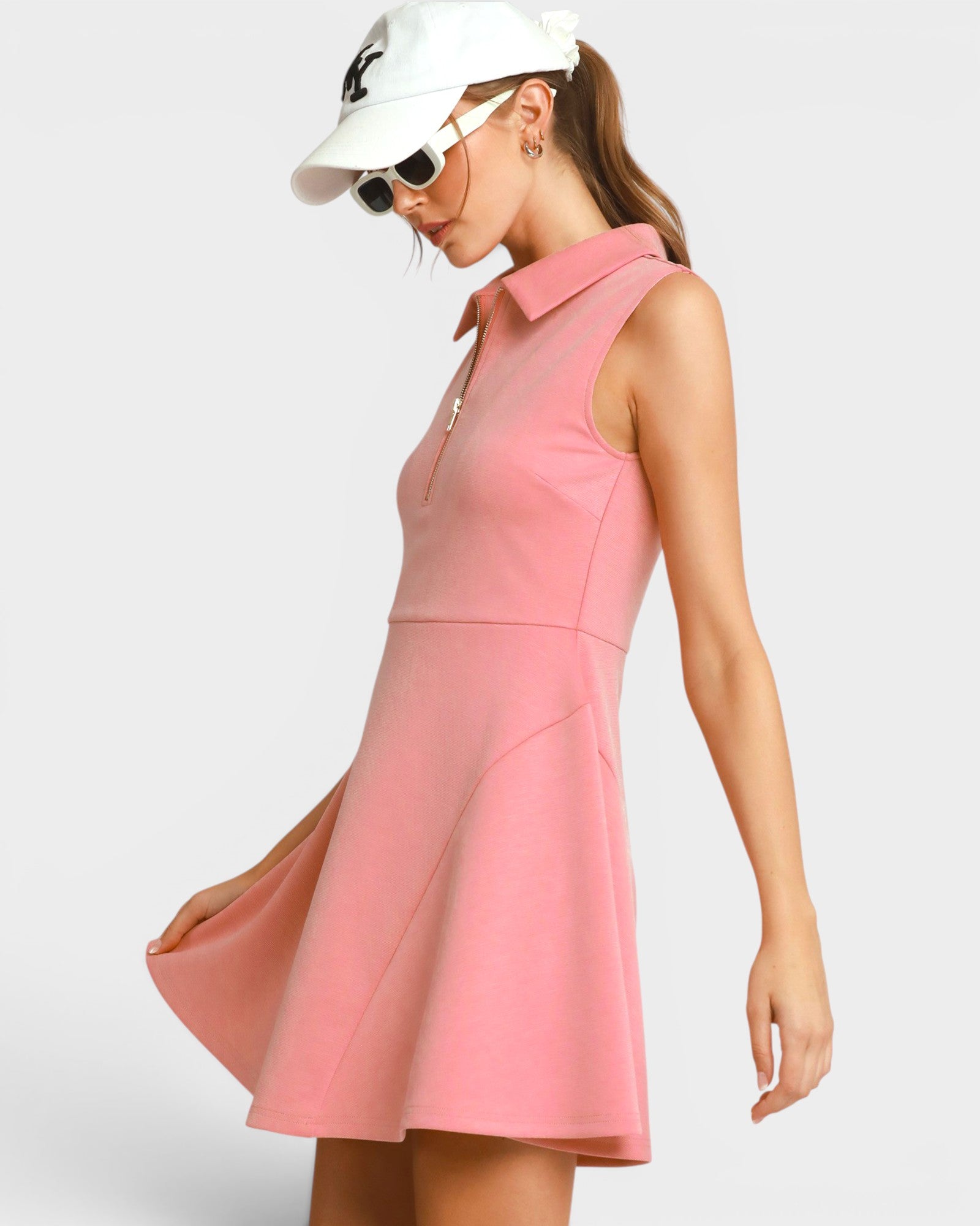 Woman wearing a pink dress with a white background