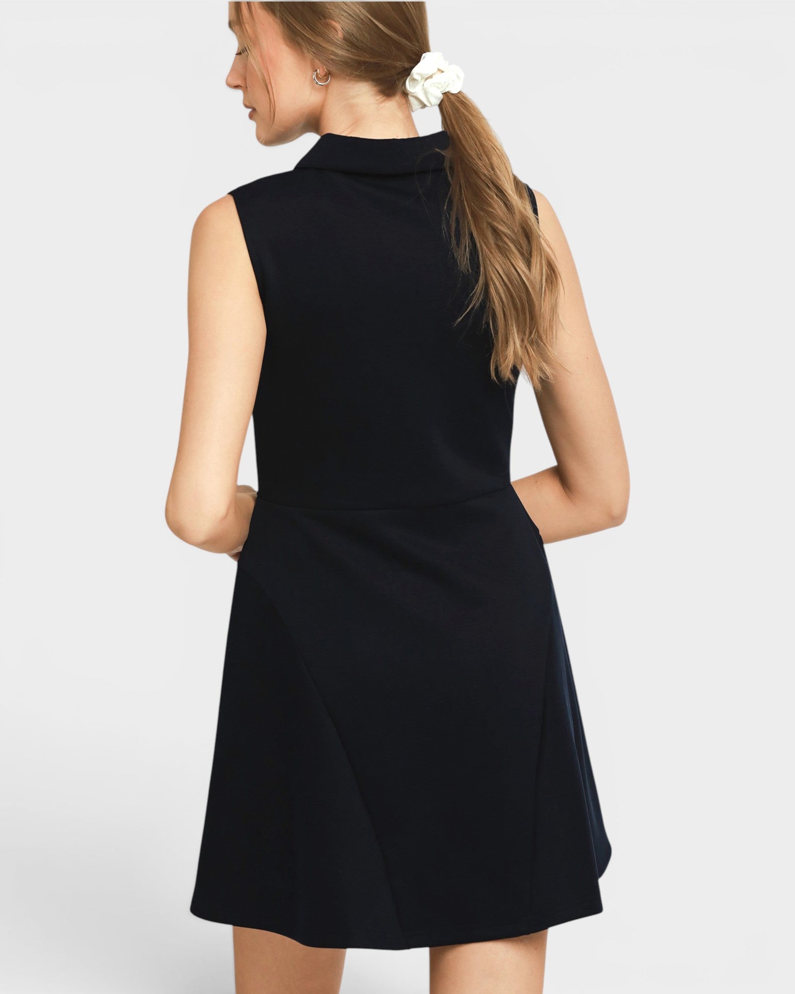 Navy sleeveless dress worn by a person on a white background