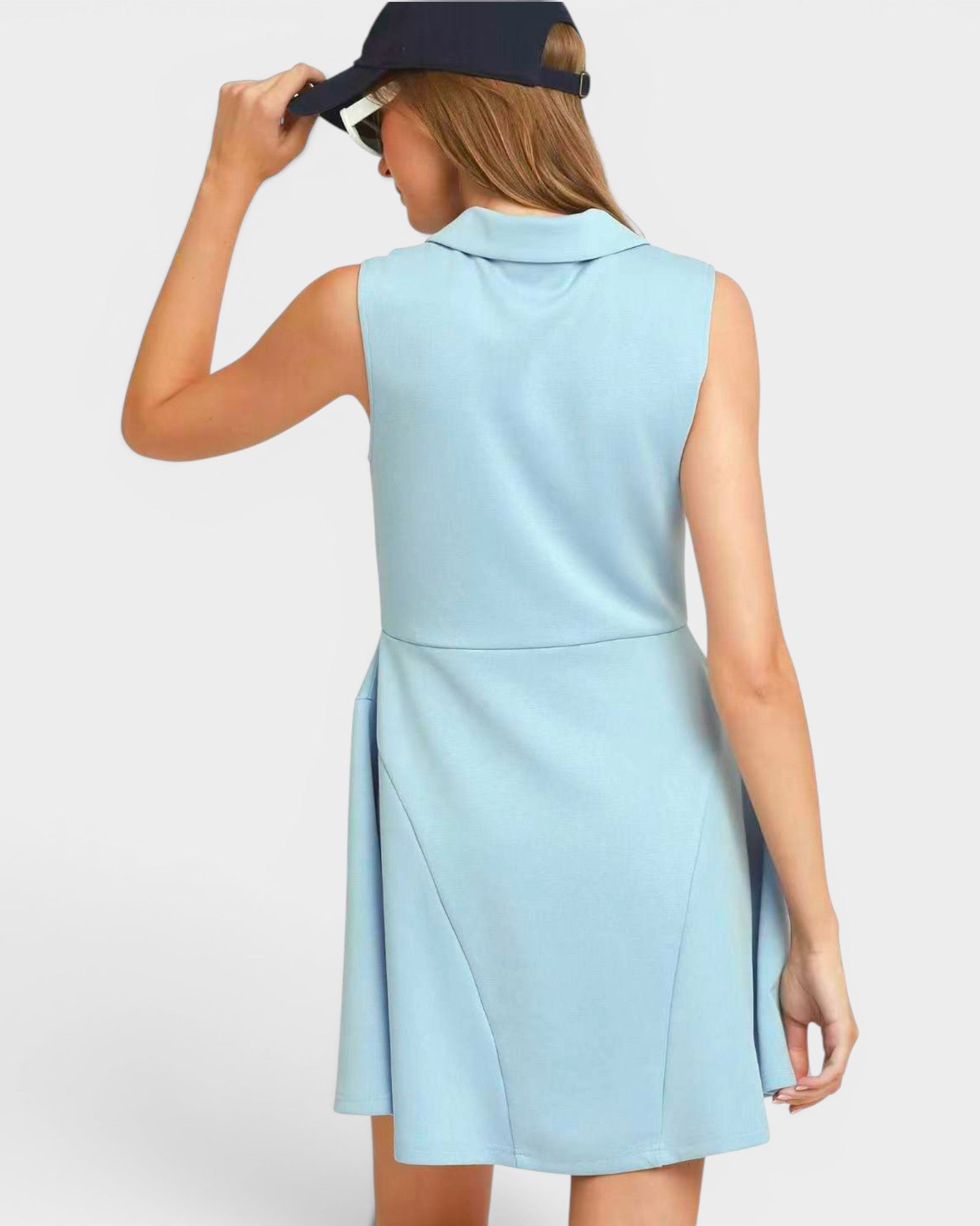 Woman wearing a light blue dress with a white background