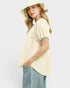 Woman wearing a light yellow top and striped pants with a white background