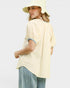 Woman wearing a light yellow blouse and hat on a white background