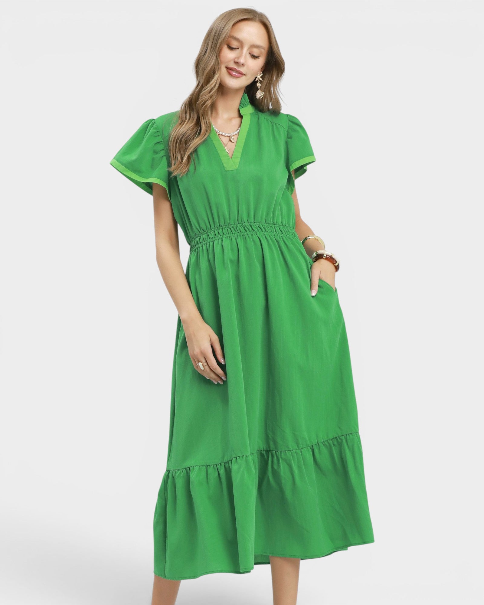 Woman wearing a green dress on a white background