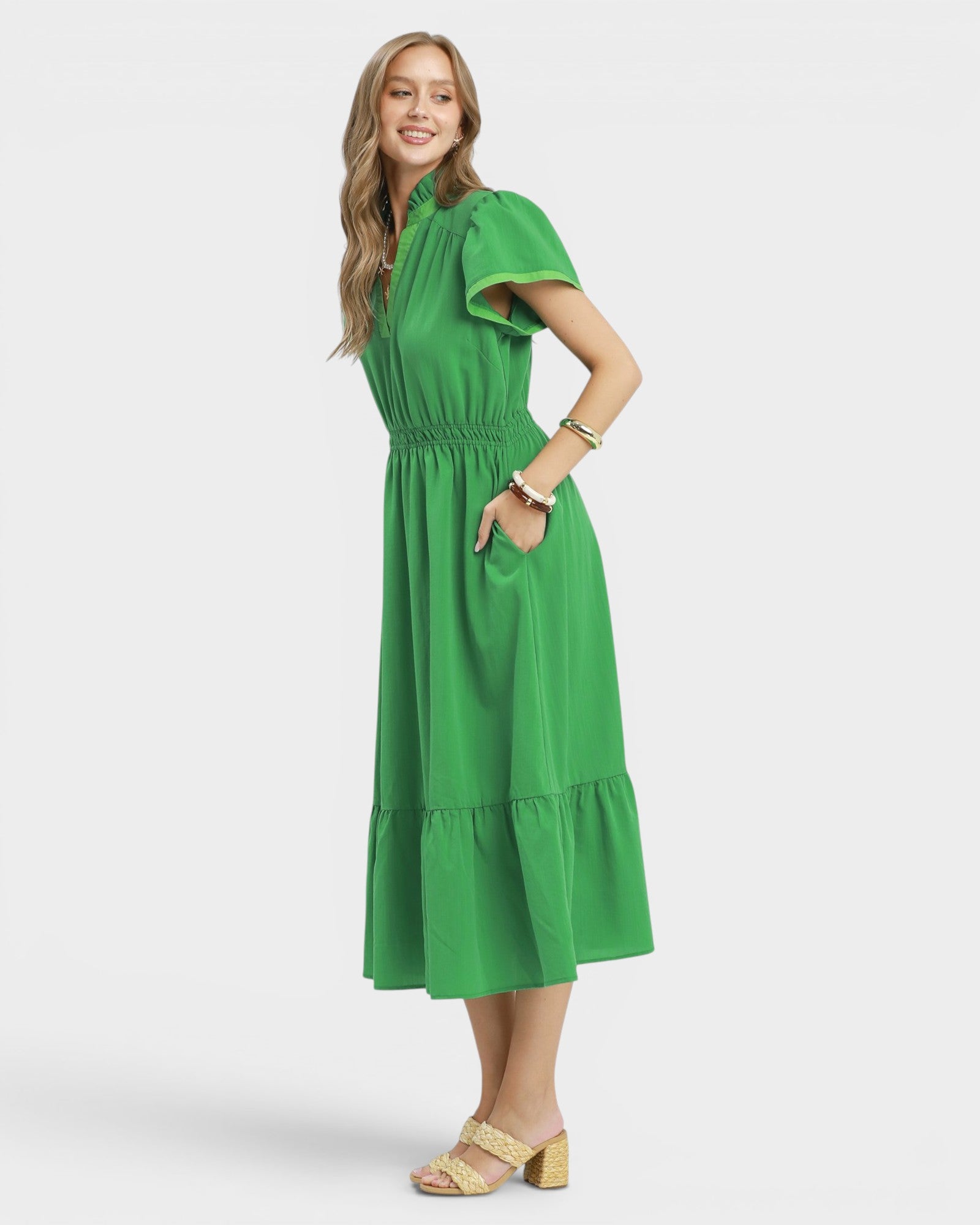 Woman wearing a green dress on a white background