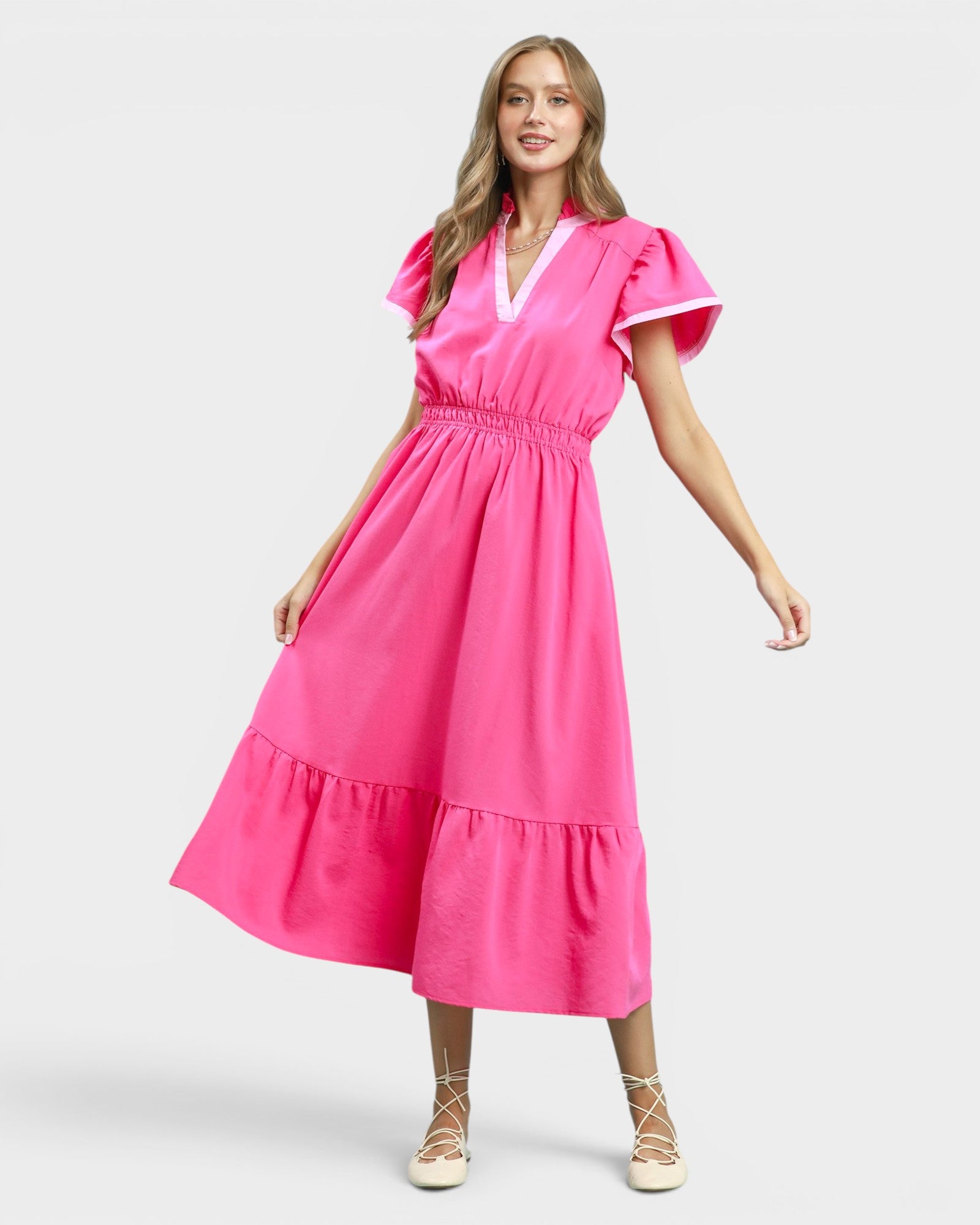 Woman wearing a pink dress on a white background