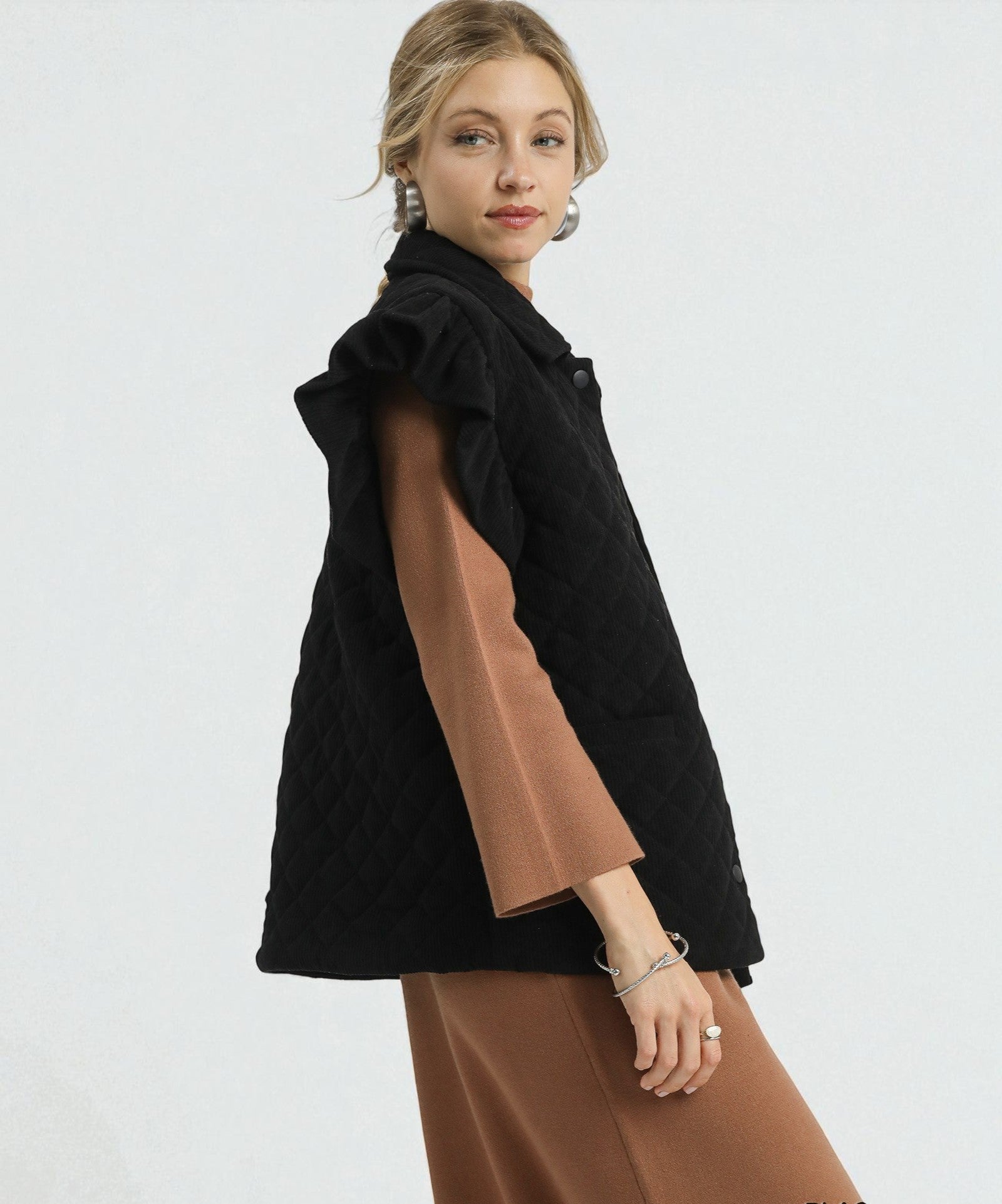 Woman wearing a black and brown outfit on a white background