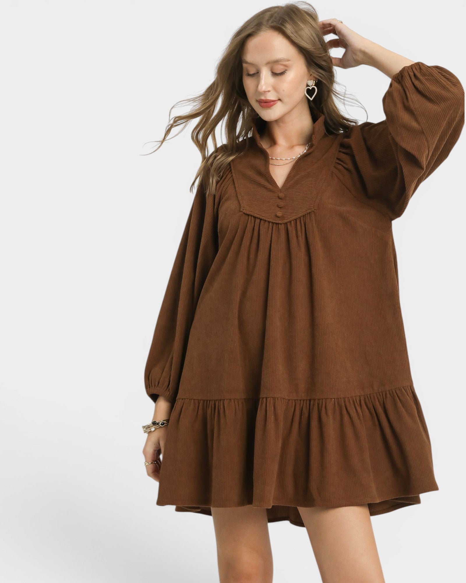 Woman wearing a brown dress on a white background