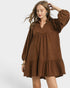 Woman wearing a brown dress on a white background