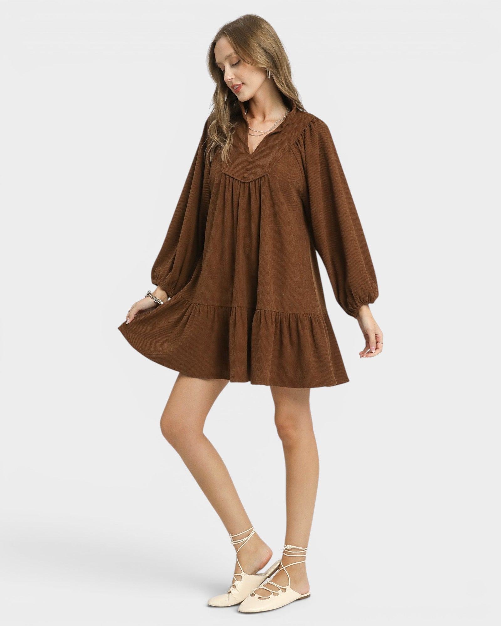 Woman wearing a brown dress on a white background