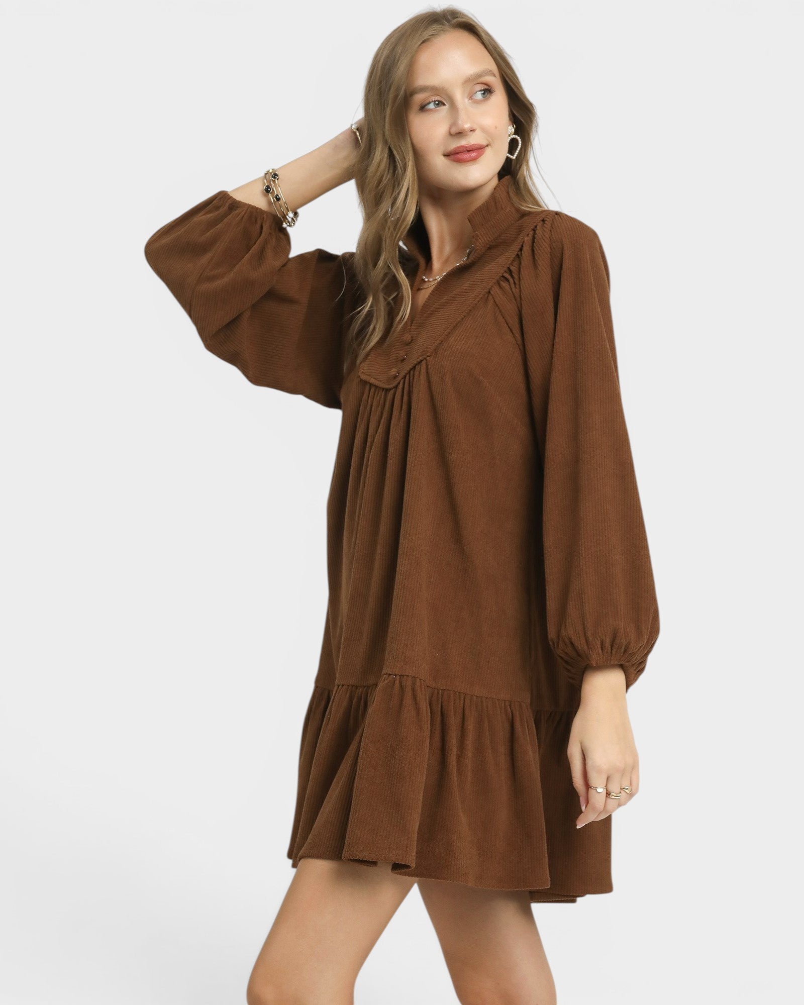Woman wearing a brown dress on a white background