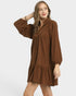 Woman wearing a brown dress on a white background