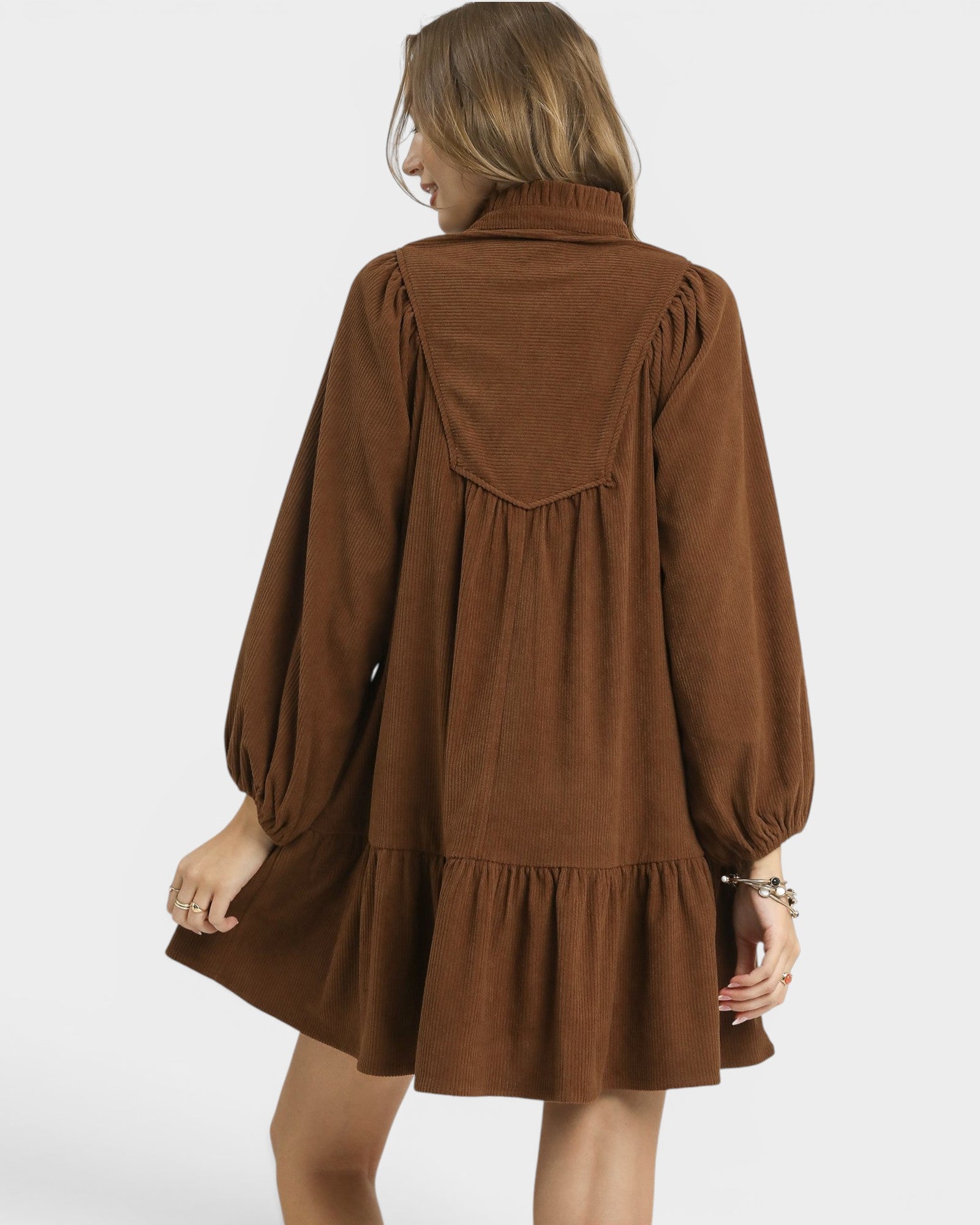 Brown dress worn by a person on a white background