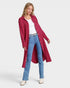 Woman wearing a red coat, white shirt, and blue jeans on a white background