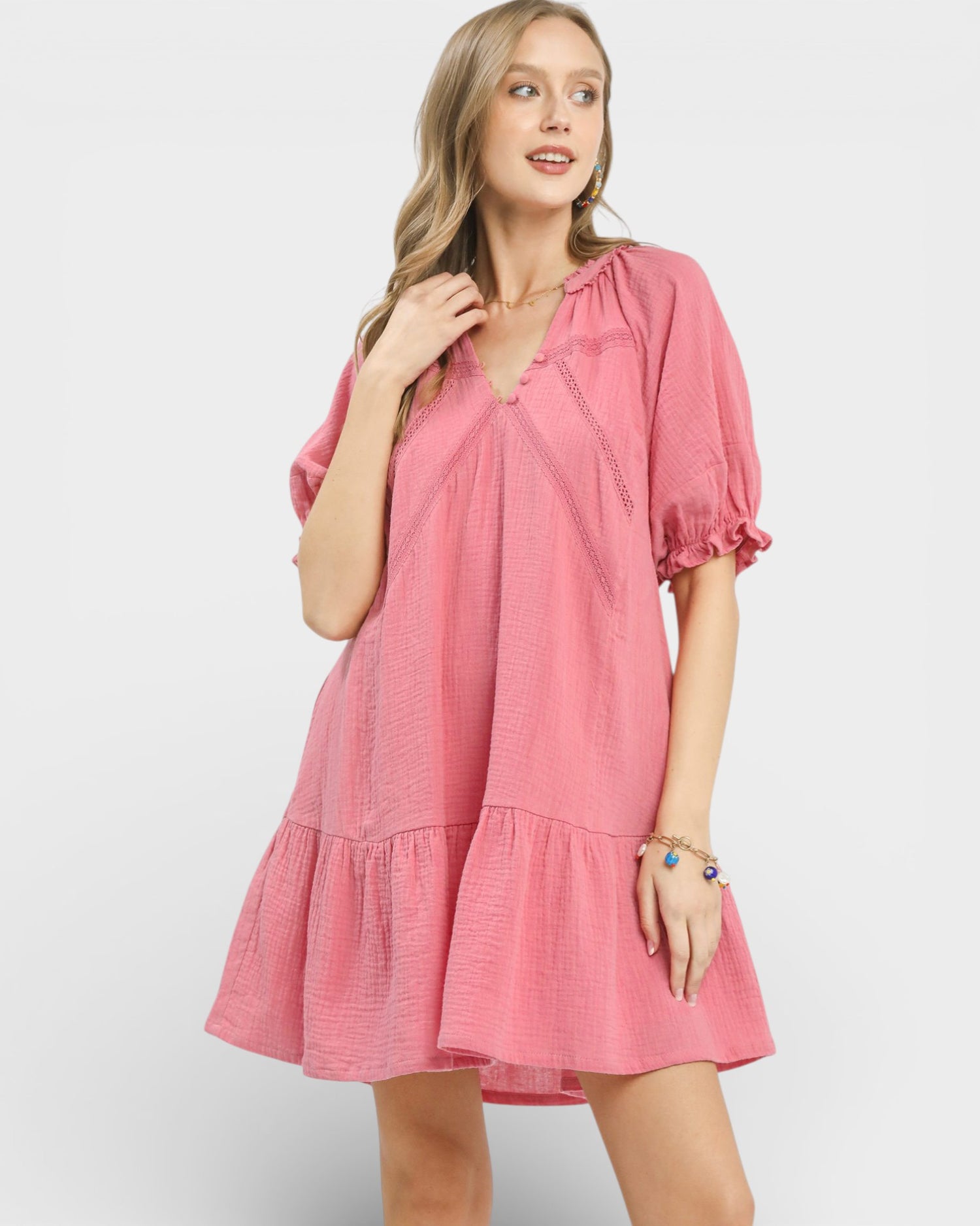 Woman wearing a pink dress against a white background