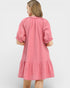 Pink dress with ruffled sleeves on a white background
