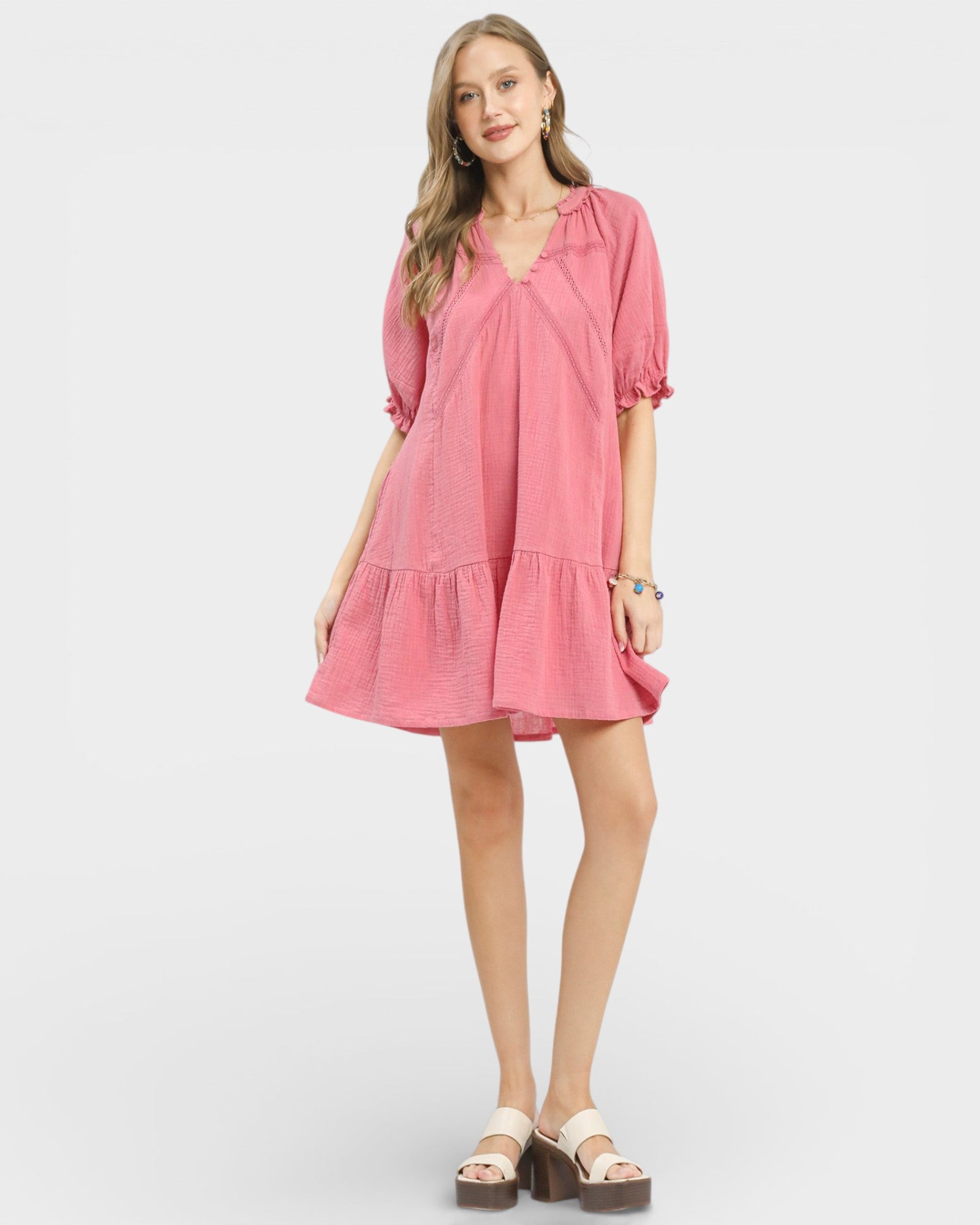 Woman wearing a pink dress on a white background
