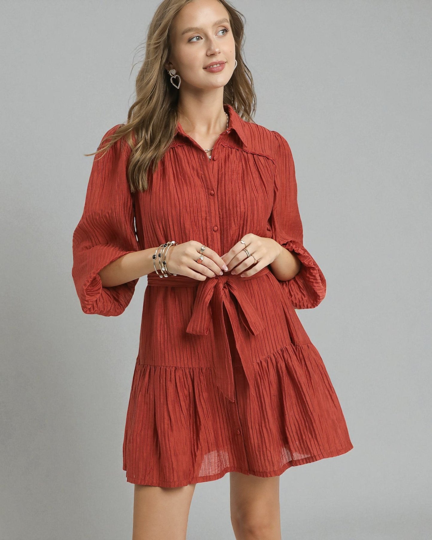 Woman wearing a red dress with a gray background