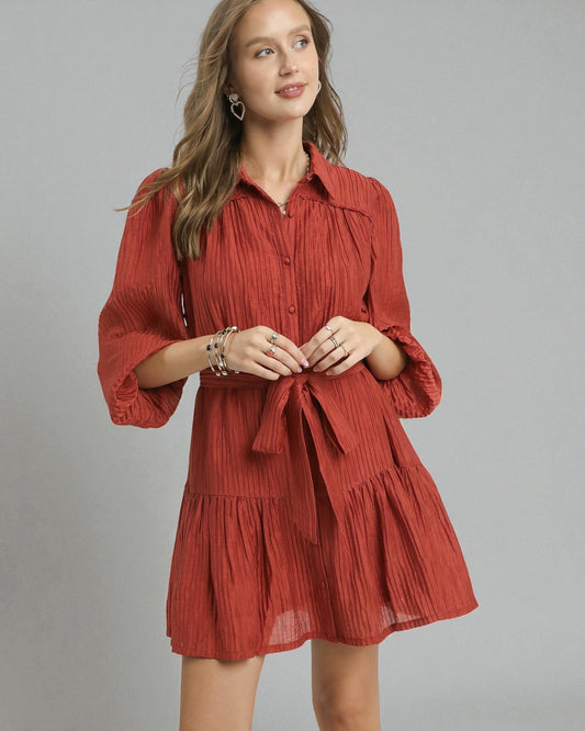 Woman wearing a red dress with a gray background