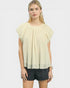 Woman wearing a light yellow blouse with short sleeves on a white background
