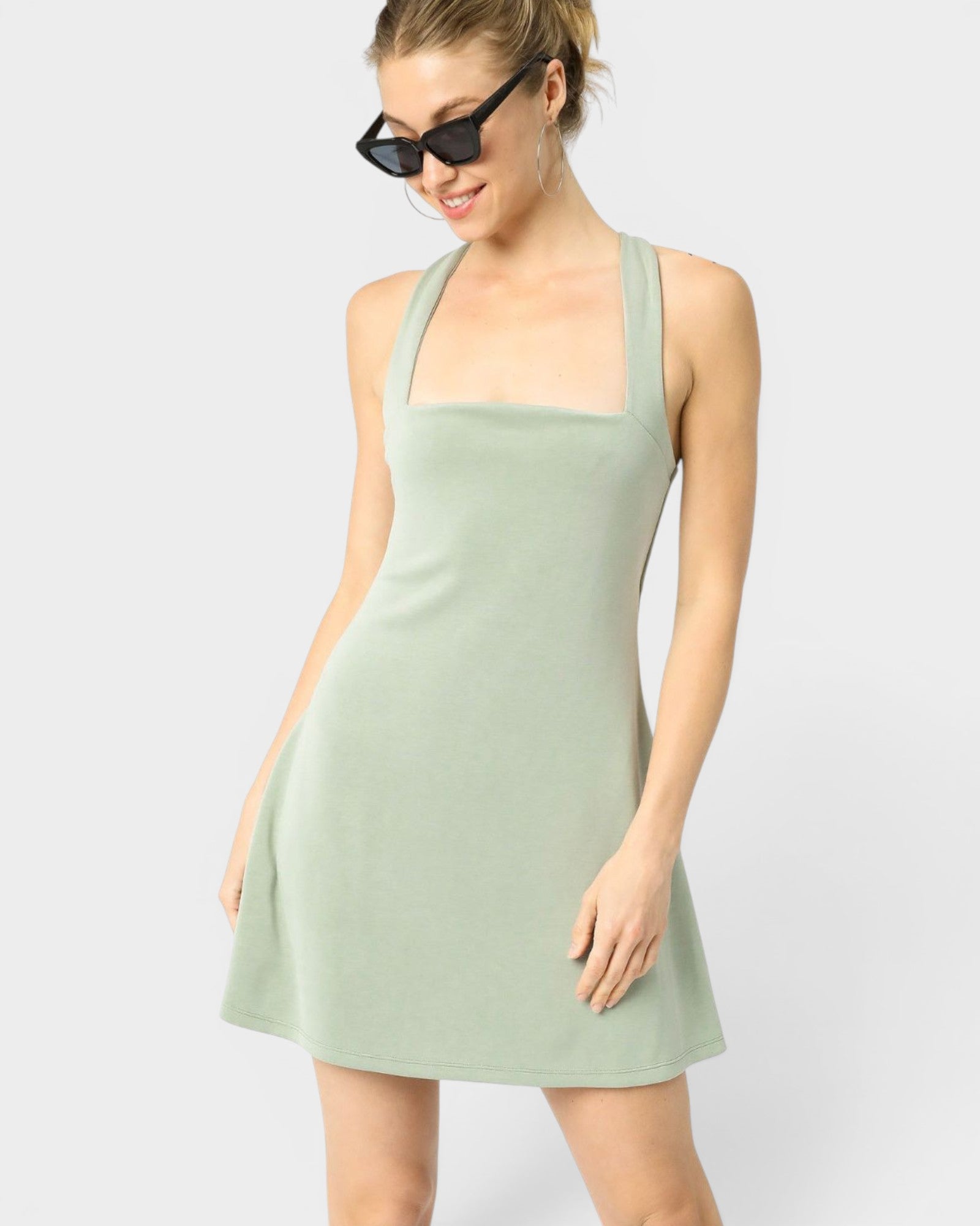 Woman wearing a light green dress on a white background