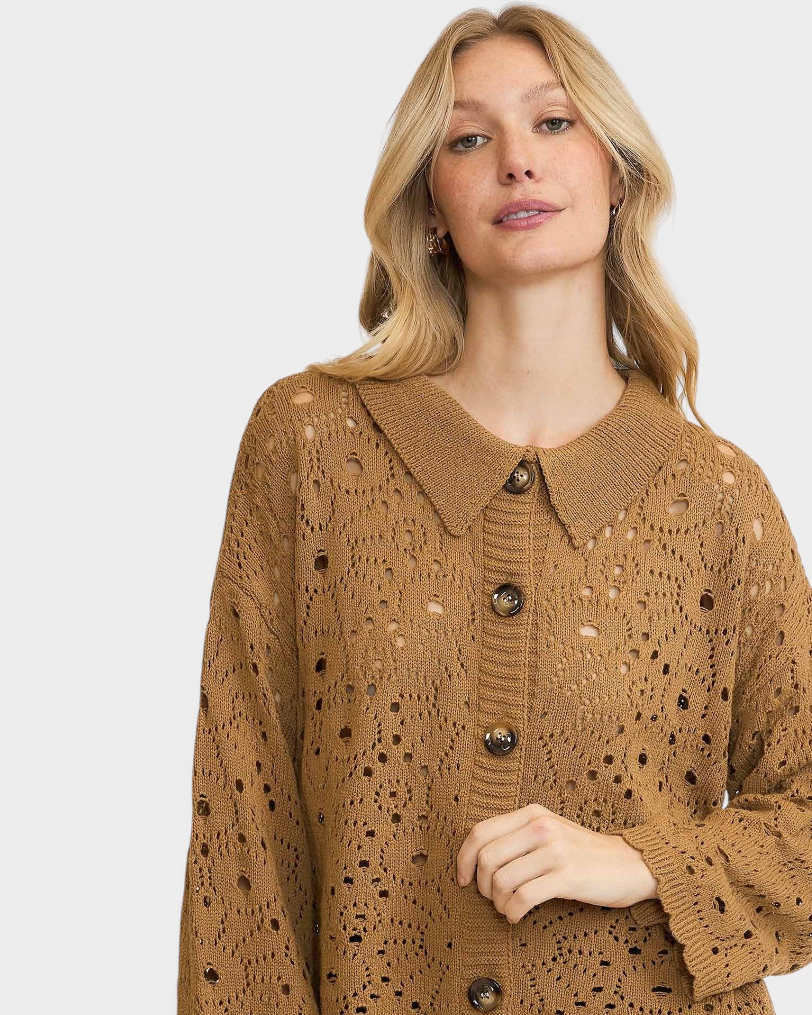 Woman wearing a brown knitted cardigan with a collar on a white background