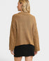Person wearing a brown knitted sweater with cut-out sleeves on a white background