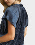 Navy blue textured blouse worn by a person on a white background