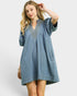 Woman wearing a denim dress with a white background