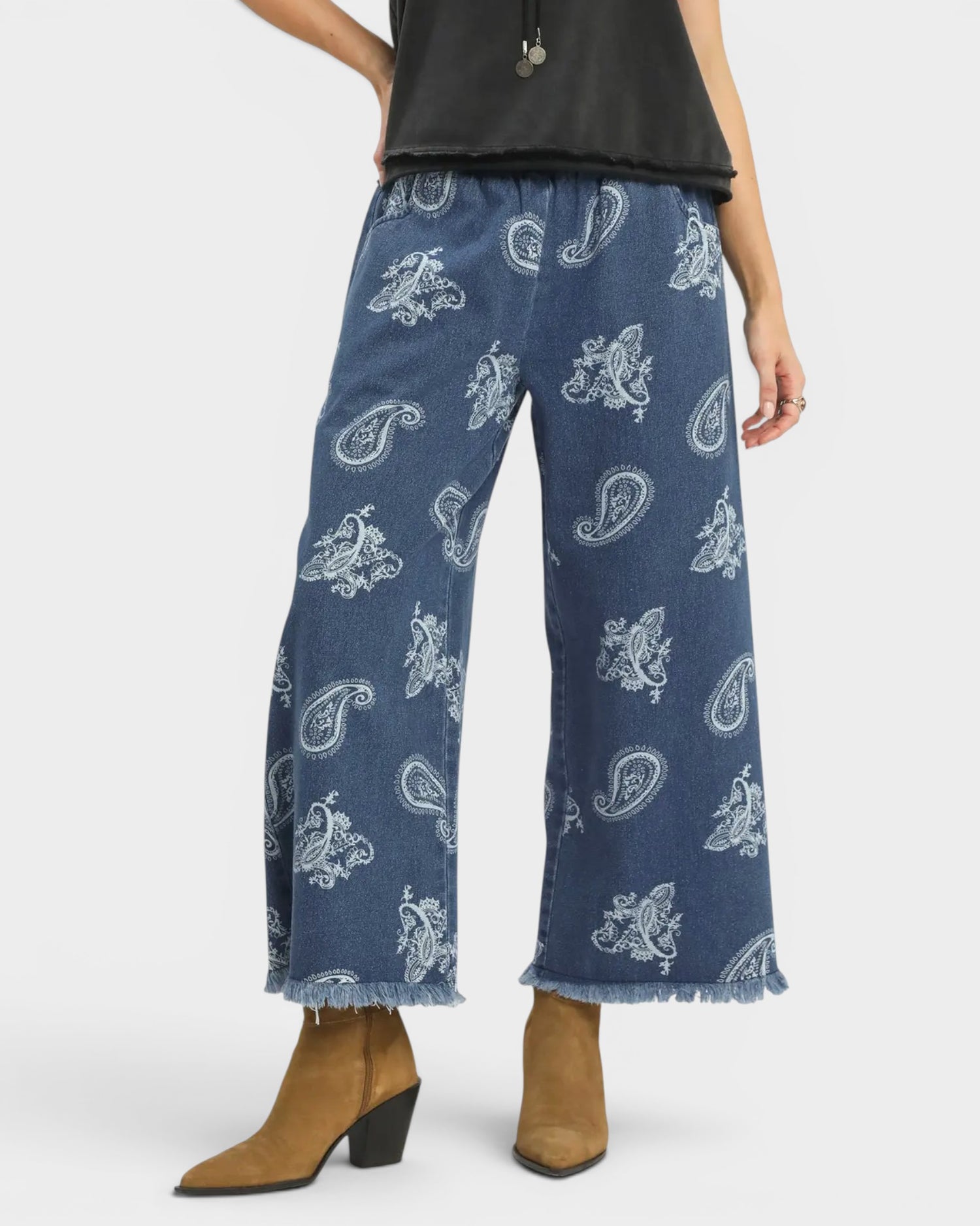 Blue paisley-patterned pants worn by a person on a white background