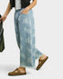 Person wearing light blue paisley-patterned pants with a white background