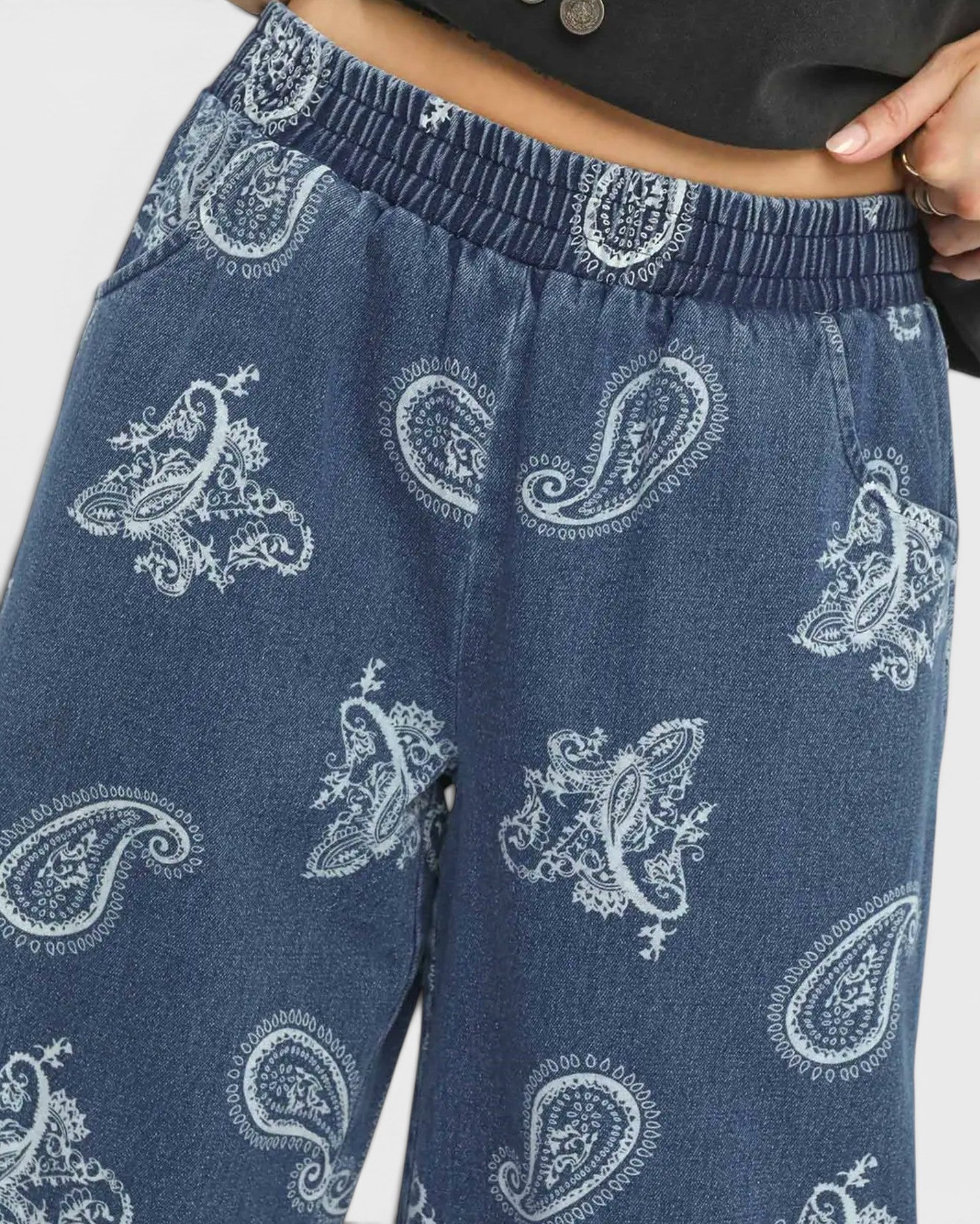 Blue pants with white paisley patterns on a plain background