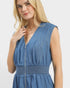 Woman wearing a blue dress with a white background