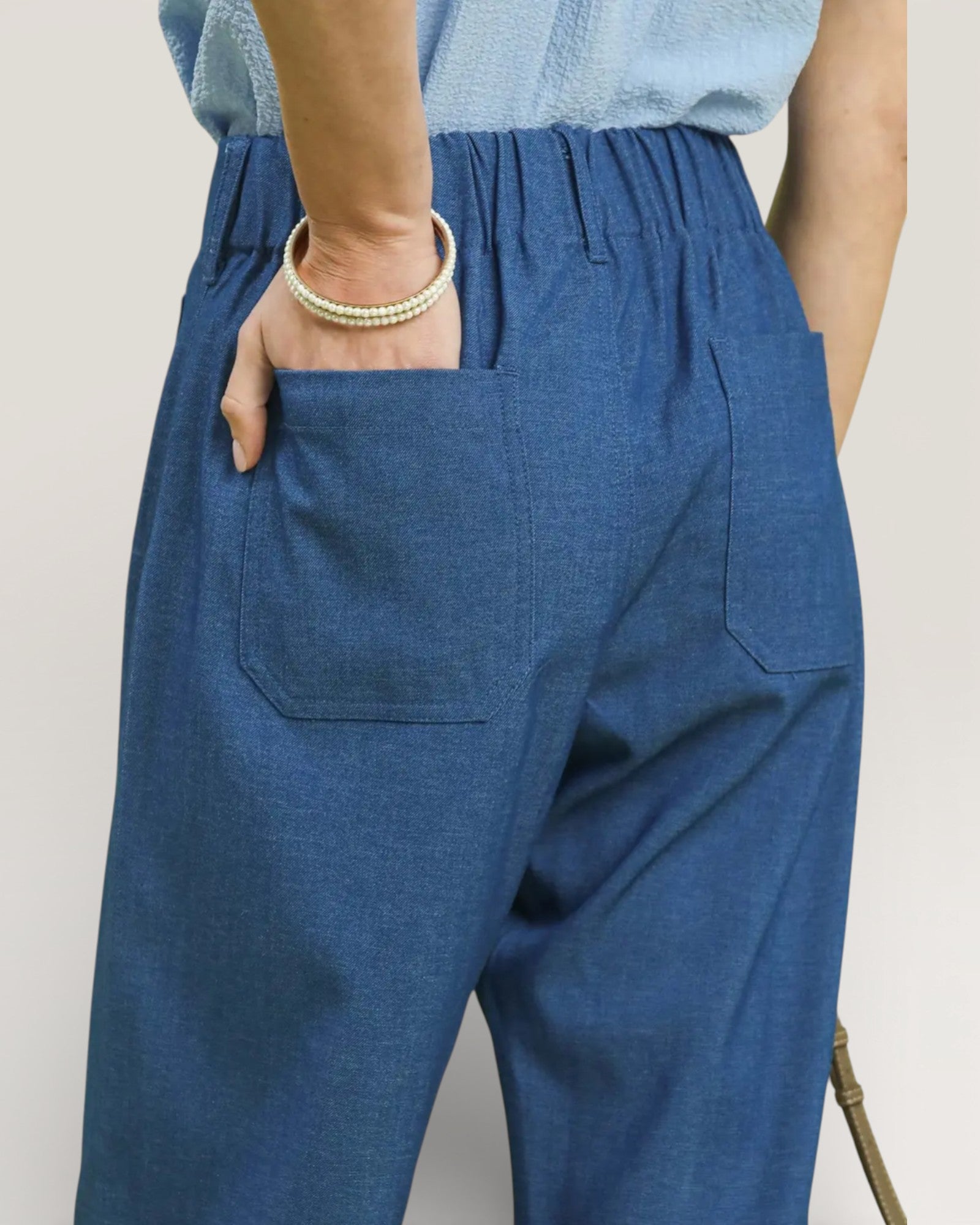 Blue pants worn by a person with a neutral background