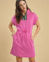 Woman wearing a pink dress with a beige background