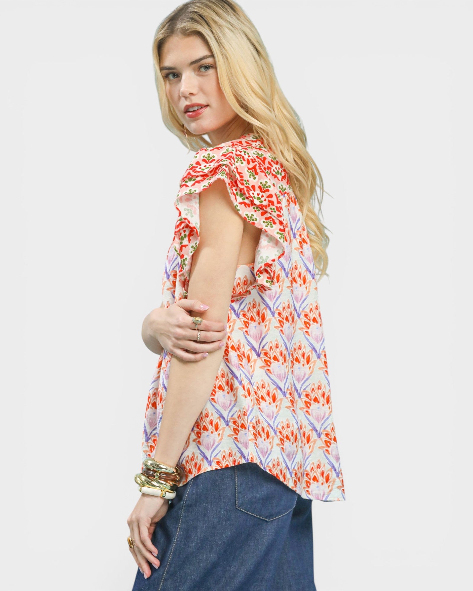 Woman wearing a floral patterned top with a plain background