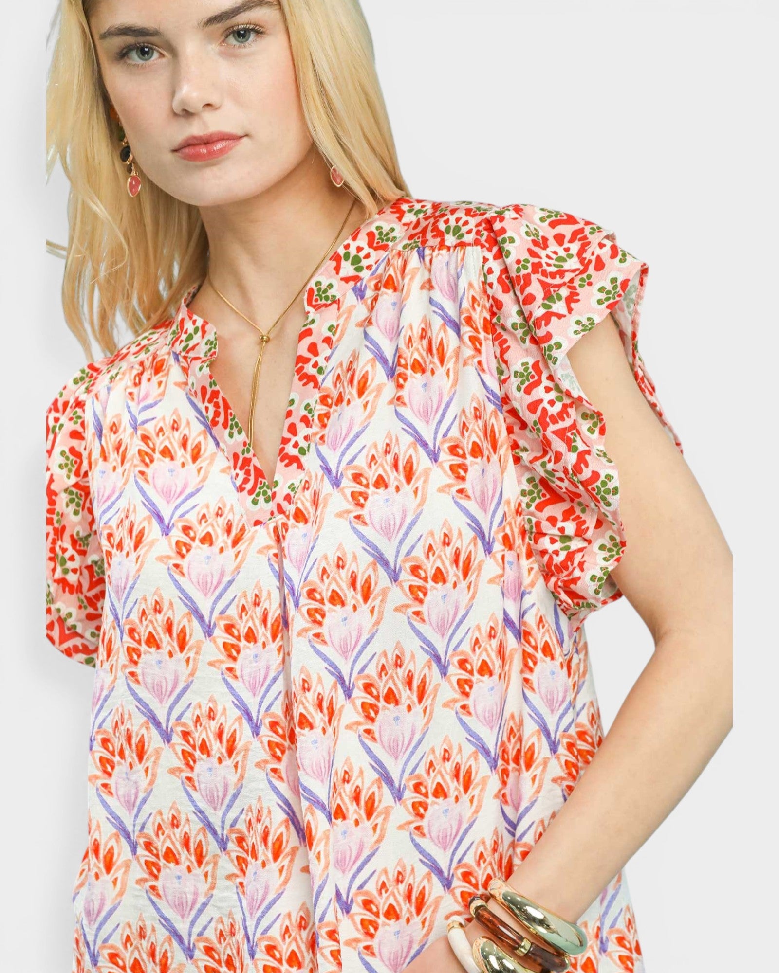 Woman wearing a colorful floral dress on a white background