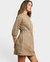 Woman wearing a beige textured dress on a white background