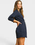 Woman wearing a navy blue dress on a white background