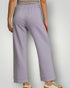 Person wearing light purple pants on a plain background