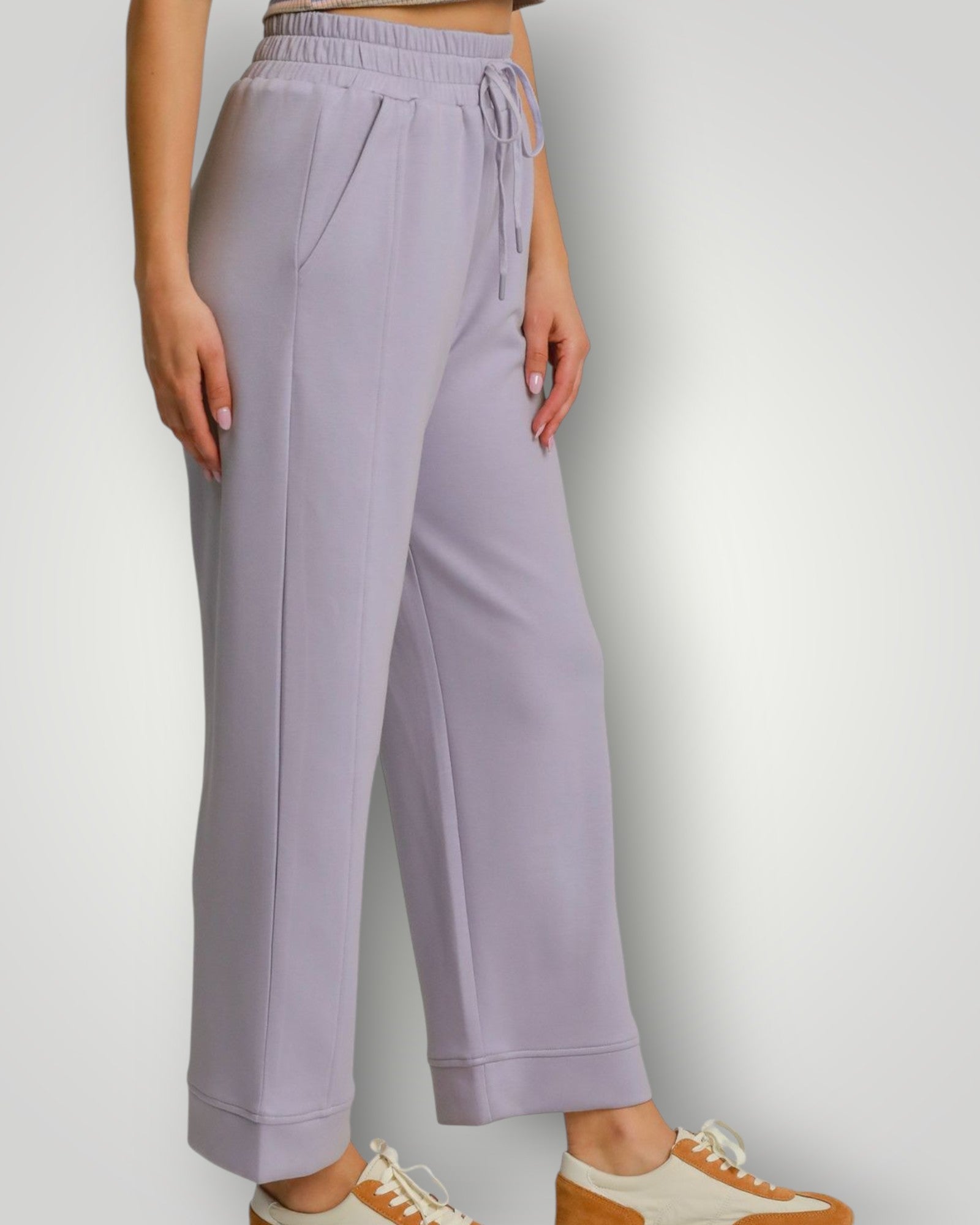 Lavender pants worn by a person on a plain background