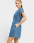 Woman wearing a blue denim dress on a white background