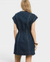 Woman wearing a navy denim dress on a white background