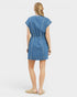 Woman wearing a blue denim dress on a white background