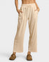 Beige lounge pants worn by a person on a white background