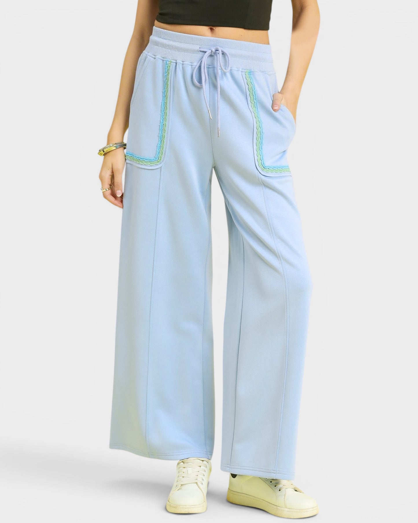 Light blue wide-leg pants with drawstring waist and pocket details on a white background