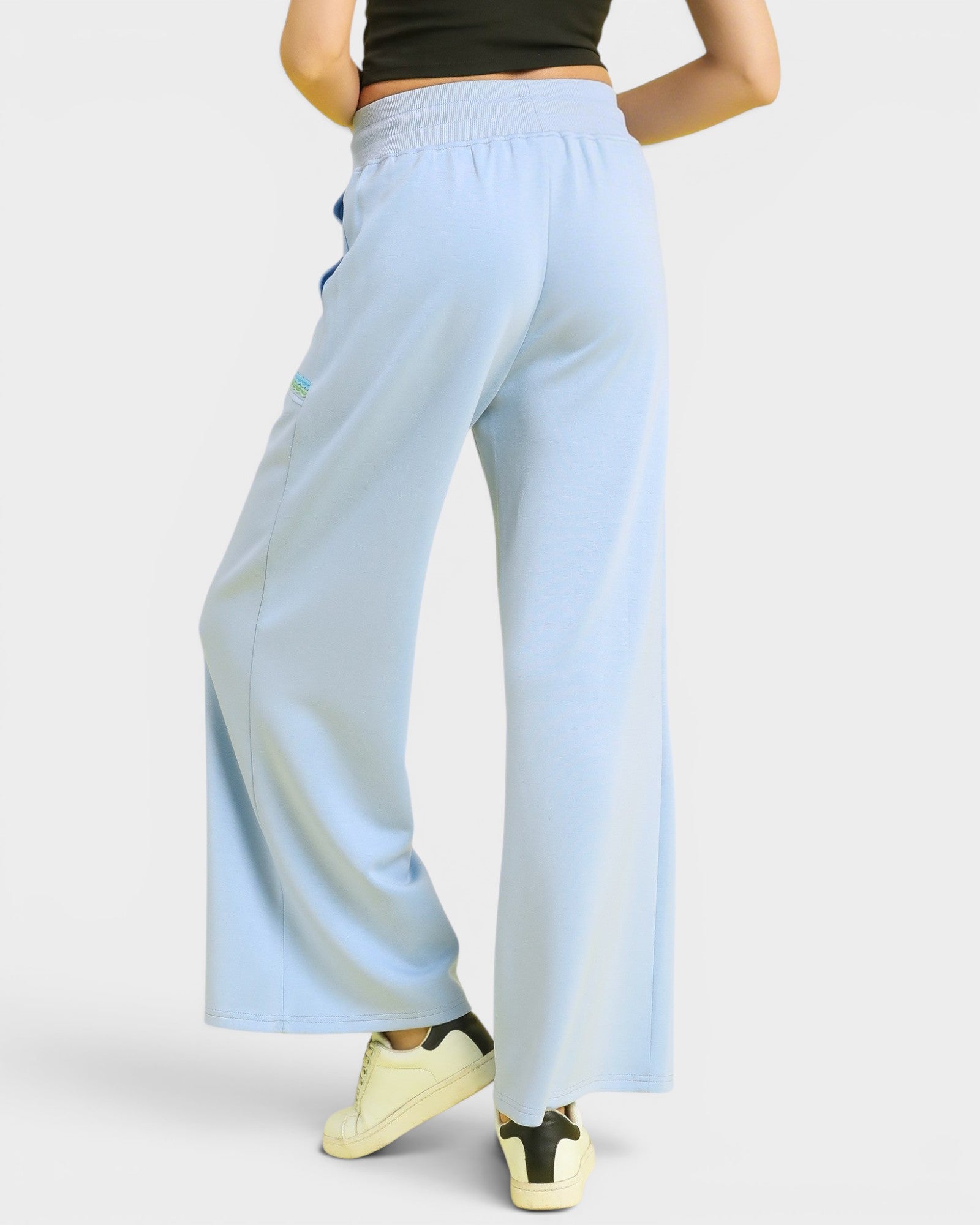 Light blue wide-leg pants worn by a person on a white background