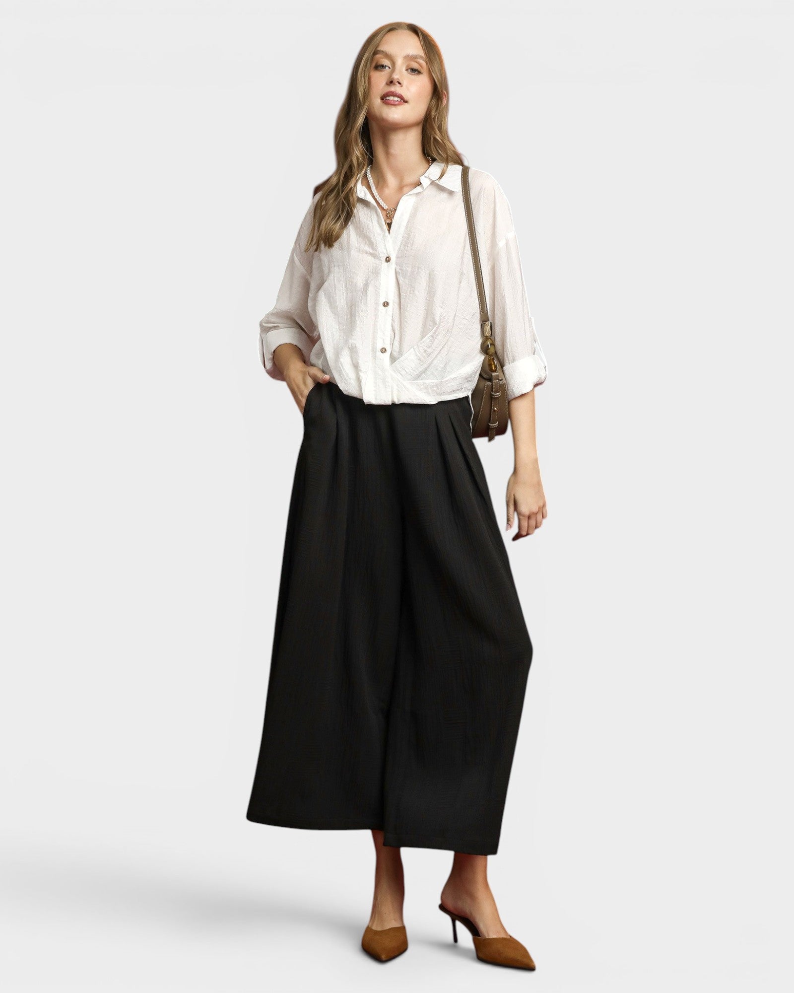 Woman wearing a white blouse and black skirt on a white background